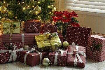 Many different gifts under Christmas tree indoors
