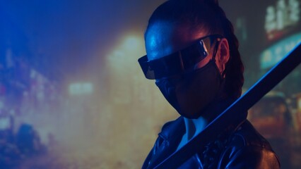 Cyberpunk ninja girl in a mask and with a katana. Beautiful female samurai woman on the background of Asian city downtown. © Acronym