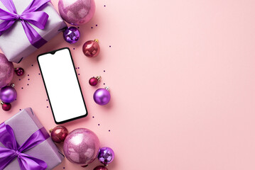 Christmas concept. Top view photo of smartphone purple gift boxes with ribbon bows pink violet baubles and confetti on isolated pastel pink background with copyspace