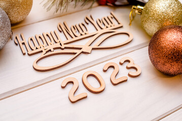 Happy new year 2023 on wooden white background