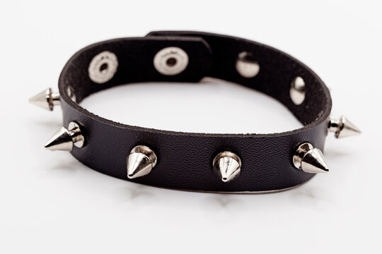 a full stud bracelet with black leather on a white background