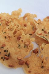 Indonesian snack called rempeyek kacang kucai with white background