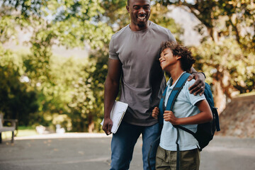 Happy student and teacher standing together outdoors - obrazy, fototapety, plakaty