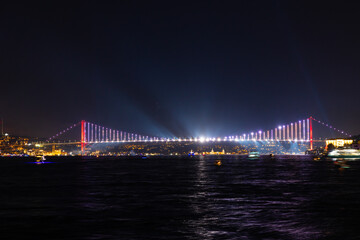 Istanbul night. Spotlight show on Bosphorus Bridge.
