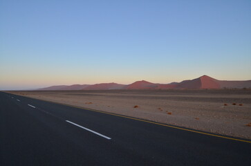 Fototapeta na wymiar Lonely Road in dry pan of Sossusvlei Namib Naukluft National Park