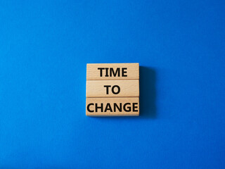 Time to change symbol. Concept word Time to change on wooden blocks. Beautiful blue background. Business and Time to change concept. Copy space