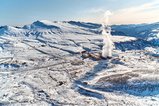 Aerial view to geothermal power plant in mountain. Clean green renewable energy in Kamchatka.