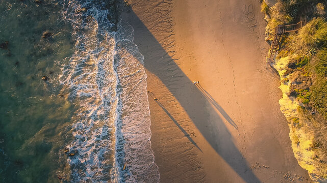 Aerial View of couples during a sunset Malibu Beach Walk, California, USA