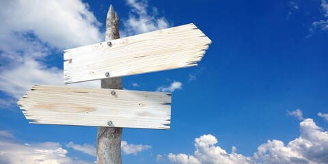 Wooden signpost with two clear arrows