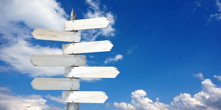 Naklejki Wooden signpost with seven clear arrows