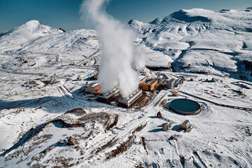 Aerial view to geothermal power plant in mountain. Clean green renewable energy in Kamchatka. - 550790565