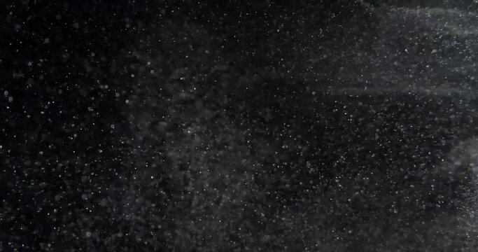 Super slow motion abstract particles on black background. Filmed with RED camera. High quality 4k footage