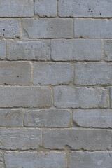 Fototapeta premium The texture of the masonry walls of cinder blocks. Slightly pink shade of stone. Vertical Format