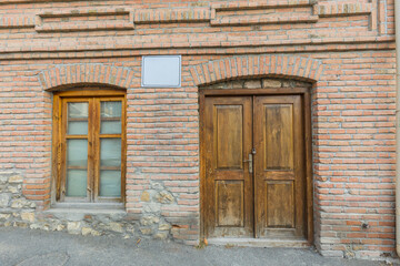 Fototapeta na wymiar Old door and window in a brick wall