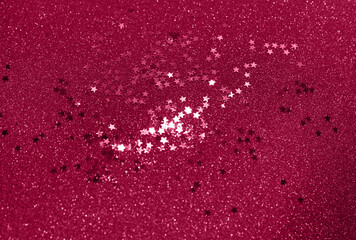 Festive background with glitters in trendy color viva magenta