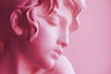 Close-up of a plaster bust of Sappho. Side view, place for text. New 2023 trending PANTONE 18-1750 Viva Magenta color.
