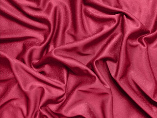 Viva magenta shiny crumpled fabric background. Color of the year 2023