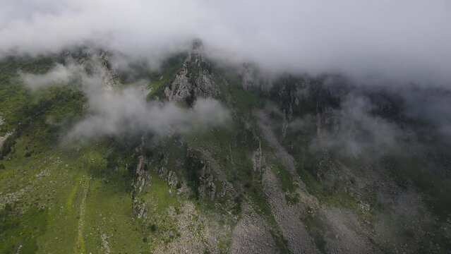Foggy, cloudy, smoky mountains formed by steep cliffs. Peaks that are hard to reach.