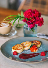 Cottage cheese pancakes or syrniki on a plate