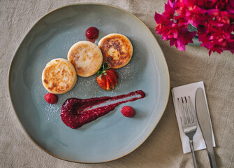 Cottage cheese pancakes or syrniki on a plate