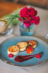 Cottage cheese pancakes or syrniki on a plate