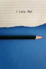 Torn lined note paper with text written I LOVE ME , and a pencil on blue background with copy...