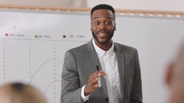 Black man, presentation and business speaker with a positive mindset for motivation during meeting for update, report or training. Coach, manager or presenter talking about target, vision and growth