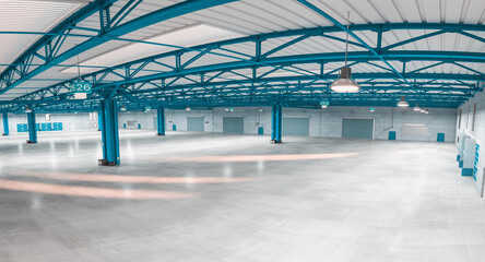 interior of an empty modern warehouse with blue structures.