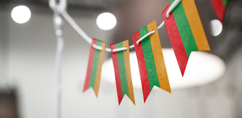 A garland of Lithuania national flags on an abstract blurred background