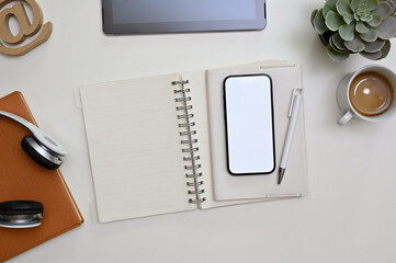 Minimal office desk workspace top view with smartphone mockup, stationery and decor.