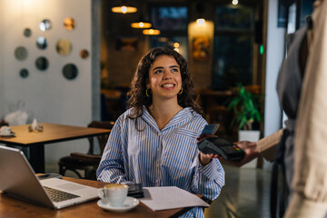 A satisfied customer pays her bill