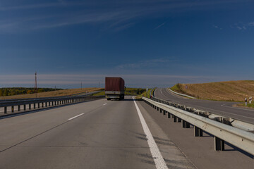 Highway wide road, transport and blue sky with clouds on a summer day