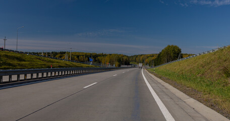 Highway wide road, transport and blue sky with clouds on a summer day