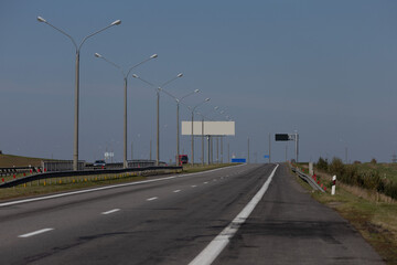 Highway wide road, transport and blue sky with clouds on a summer day