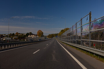 Highway wide road, transport and blue sky with clouds on a summer day