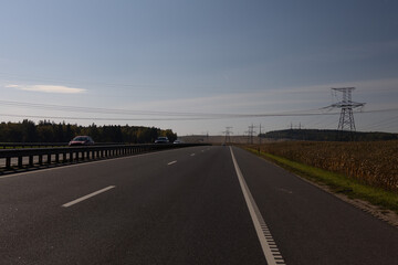 Highway wide road, transport and blue sky with clouds on a summer day