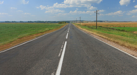Fototapeta premium Highway wide road, transport and blue sky with clouds on a summer day