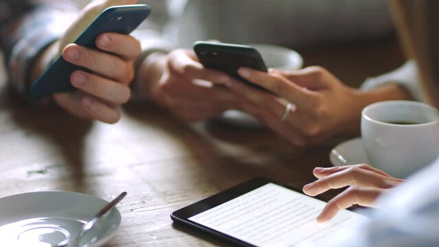 People hands, coffee break and tablet or phone for communication, cloud computing and reading news online website. Business group together at table for networking, wifi connection and social media