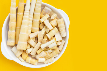 Bamboo shoots on yellow background.