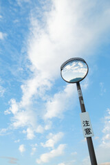 blue sky and a curve mirror