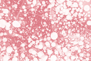 Bubbles frozen in winter ice of lake Baikal, abstract background magenta viva