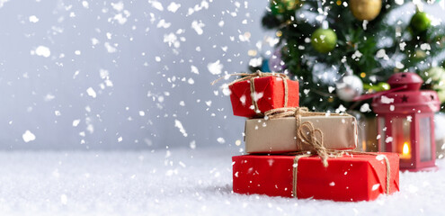 Christmas gift with tags for writing. In the background is a Christmas tree and gifts with lights. New year background.