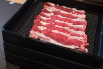 Fresh beef slices with ingredients background for Japanese shabu-shabu or Sukiyaki.