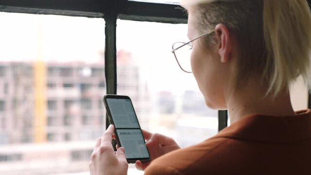 Smartphone screen, business woman and scroll on website, online infographic or information brochure for marketing strategy. Graphic designer, editor and digital worker on cellphone reading an article