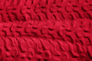 Truck tire imprint on viva magenta sand