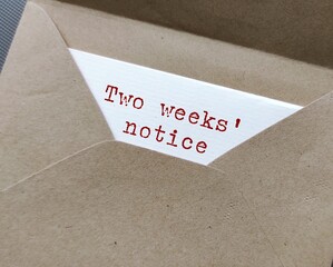 Craft envelope and document with typed text words - Two Weeks' Notice , means employee courtesy to...