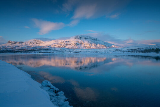 Sunrise view over calm lake at Stora Sj&ouml;fallet, National Park, Swedish Lapland, Sweden
