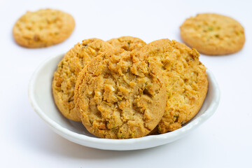 Pistachio and almond cookies on white background.