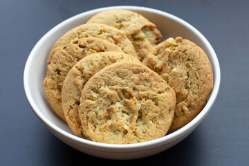 Pistachio and almond cookies on dark background.