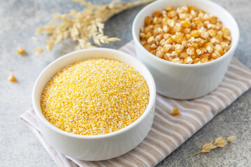 Food gluten free ingredient. Corn groats and seeds over gray stone background.